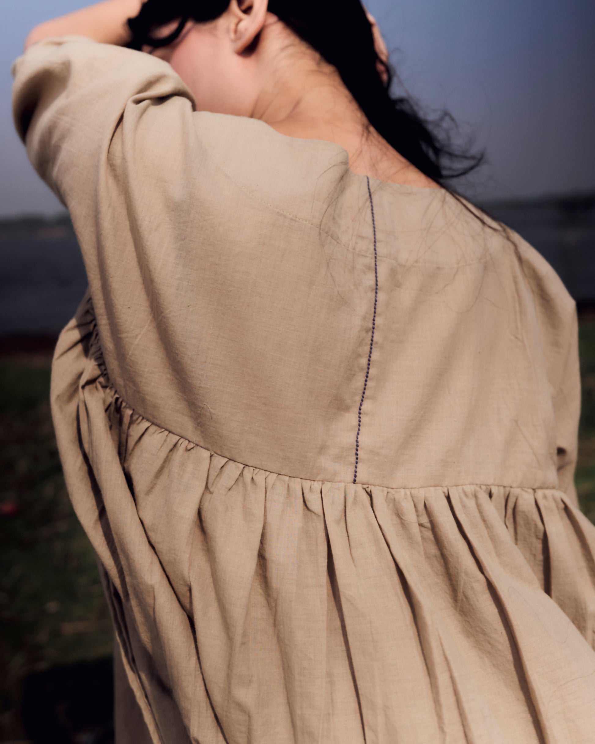 Close-up of a beige dress with a blurred background
