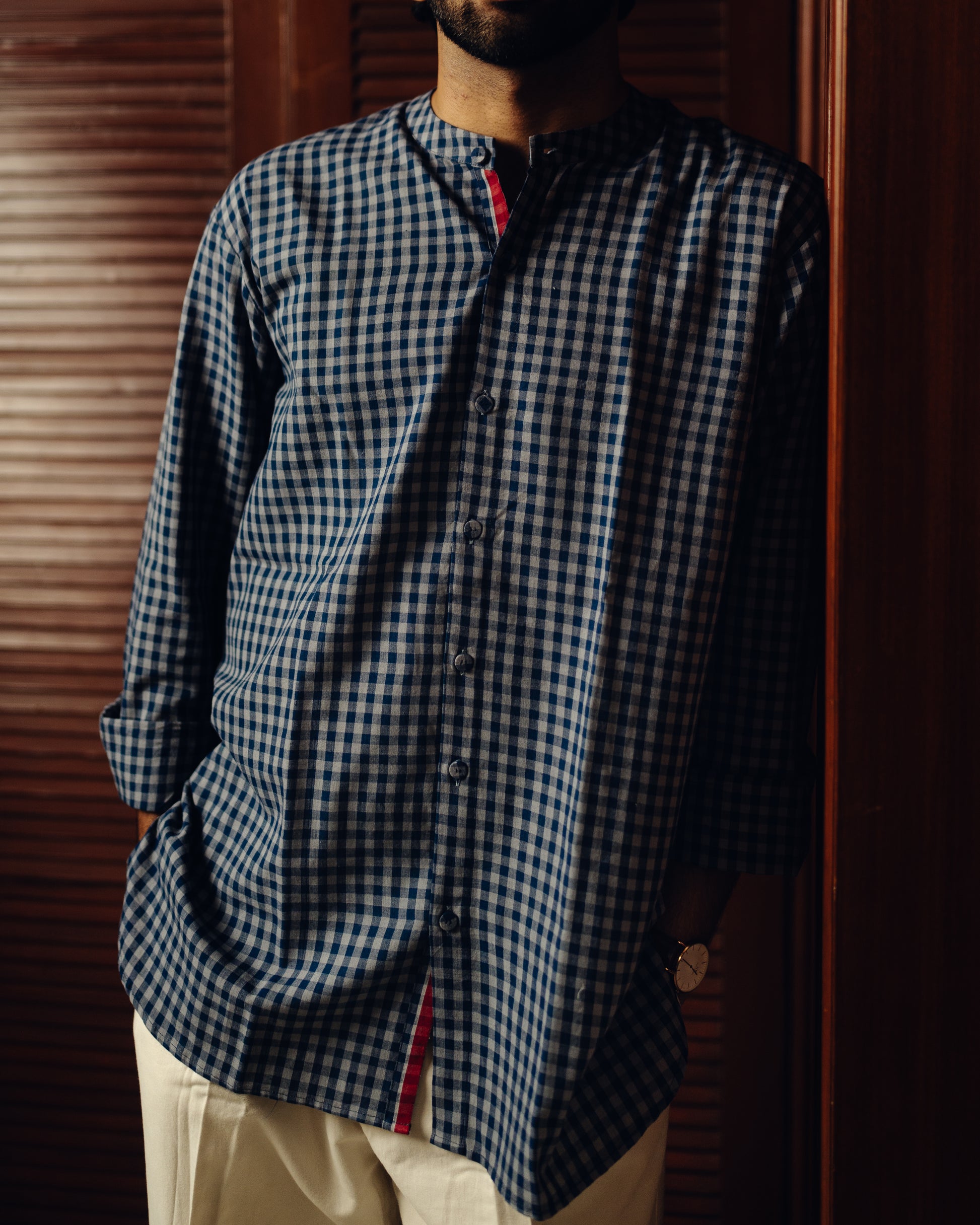 Person wearing a Blueberry checks - full sleeve shirt against a wooden background