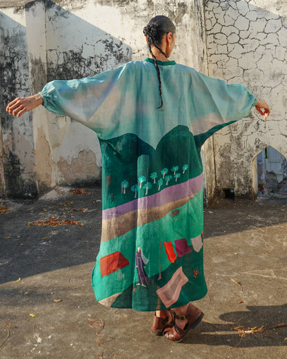 Person wearing a colorful dress with abstract patterns in an outdoor setting.