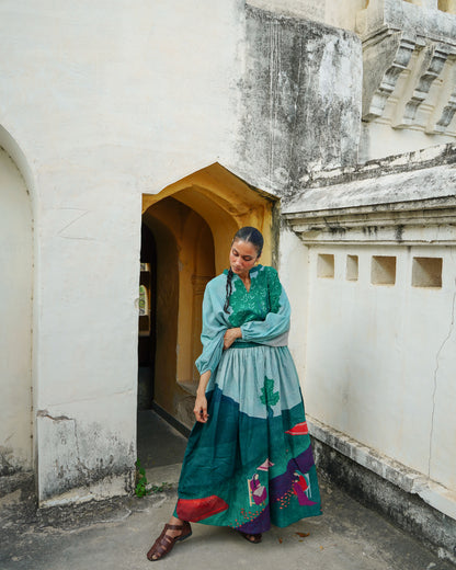 Woman in a colorful dress standing in an architectural setting