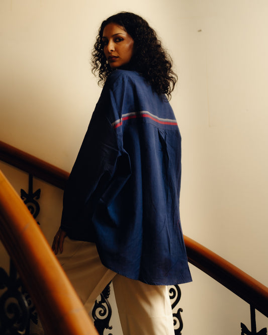 Woman wearing a Shirt - Blueberry Plain with red and white stripes on a staircase.